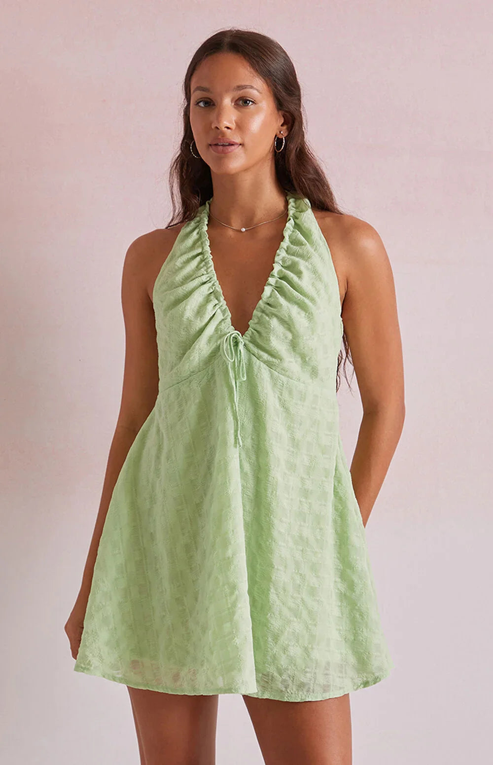 Green - Women's light pink mini dress featuring a plunging ruched halter neckline, centre tie detail, and a flared skirt in a textured crinkle fabric.