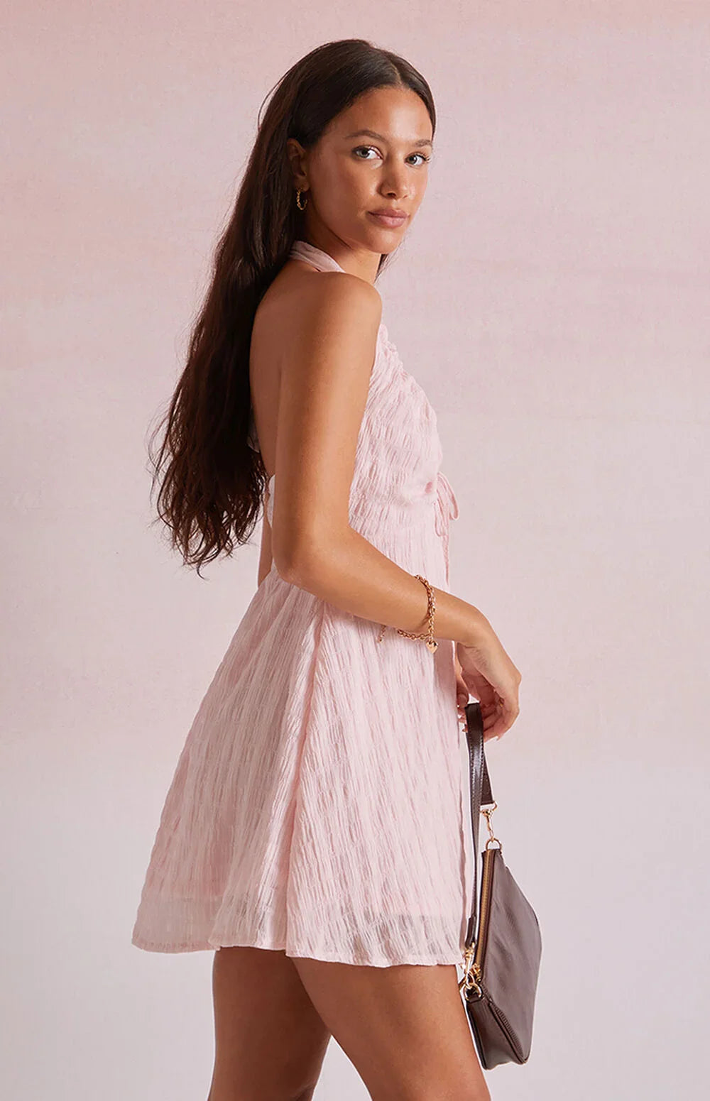 Pink - Women's light pink mini dress featuring a plunging ruched halter neckline, centre tie detail, and a flared skirt in a textured crinkle fabric.