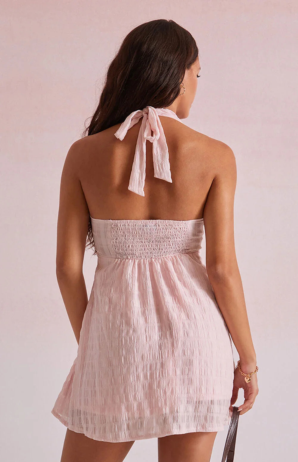 Pink - Women's light pink mini dress featuring a plunging ruched halter neckline, centre tie detail, and a flared skirt in a textured crinkle fabric.