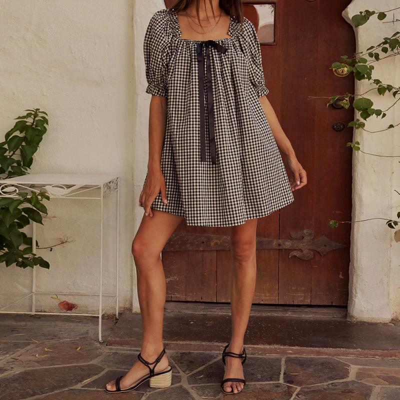Black - Women's mini-length smock dress in a gingham print, featuring a square neckline with a ribbon tie and short puff sleeves.