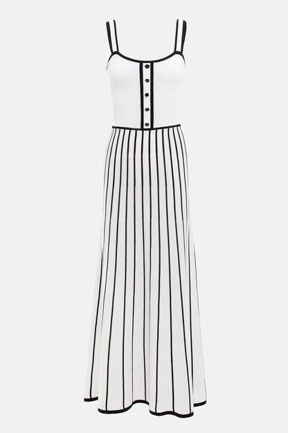 White - Woman wearing an elegant off-white midi knit dress with black contrast binding on the square neckline and straps, a buttoned bodice, and a flared A-line skirt featuring black vertical stripes.