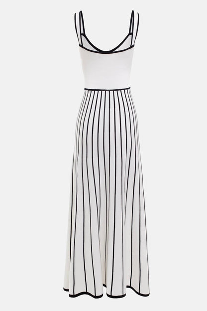 White - Woman wearing an elegant off-white midi knit dress with black contrast binding on the square neckline and straps, a buttoned bodice, and a flared A-line skirt featuring black vertical stripes.