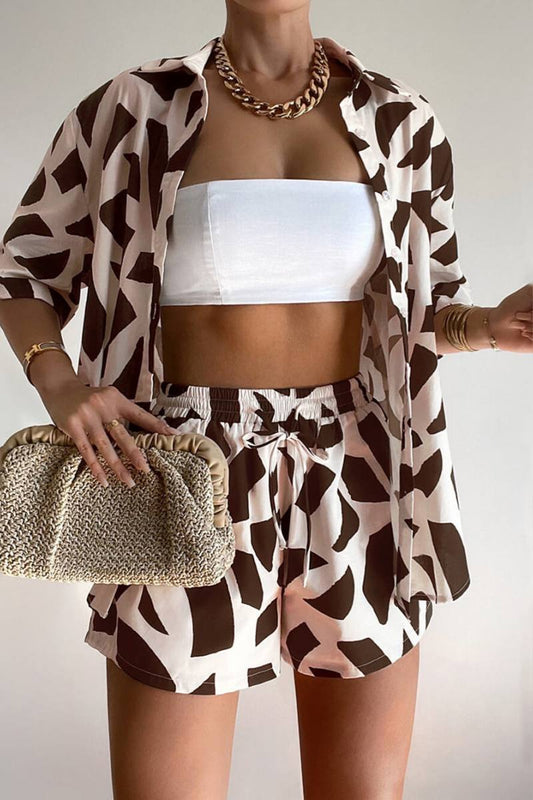 Brown - Women's two-piece co-ord set featuring an oversized button-down shirt and matching drawstring shorts in a bold brown and pale pink abstract print, styled open over a white bandeau top.