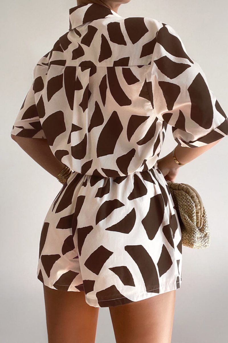 Brown - Women's two-piece co-ord set featuring an oversized button-down shirt and matching drawstring shorts in a bold brown and pale pink abstract print, styled open over a white bandeau top.