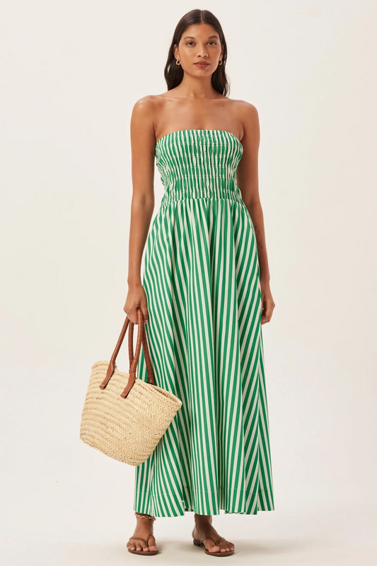 Green - Women's strapless maxi dress featuring a shirred bandeau bodice and bold green and white vertical stripes, styled with a woven straw tote bag.