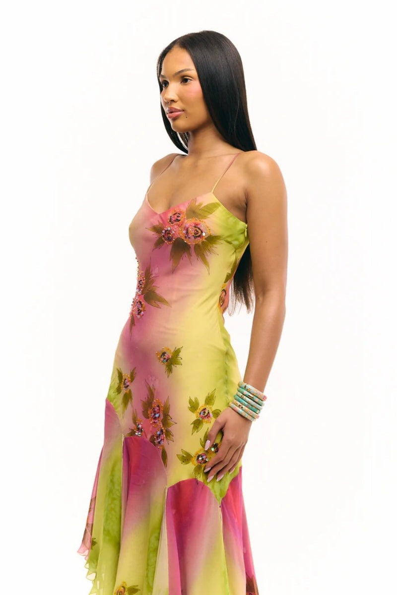 Multicolor - Women's midi-length slip dress featuring a vibrant pink and yellow ombre gradient, scattered floral print, thin straps, and a flowing asymmetrical handkerchief hemline.