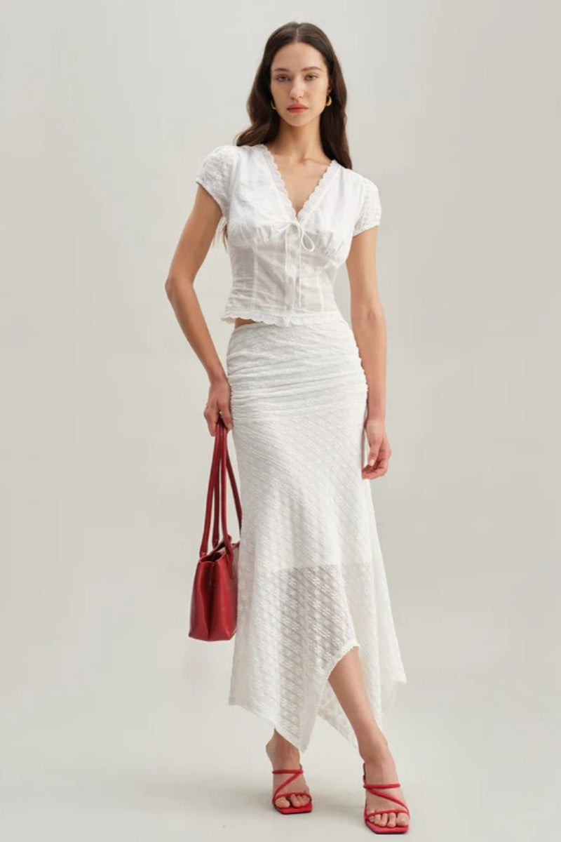 White - Women's white short-sleeve tailored blouse featuring intricate floral embroidery, a deep V-neckline with scalloped lace trim, and a delicate tie-front detail at the bust.