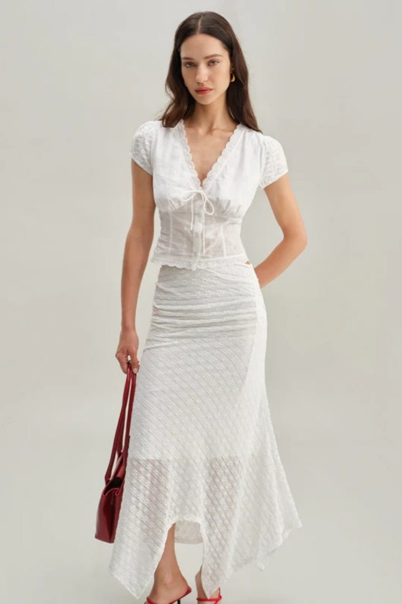 White - Women's white short-sleeve tailored blouse featuring intricate floral embroidery, a deep V-neckline with scalloped lace trim, and a delicate tie-front detail at the bust.
