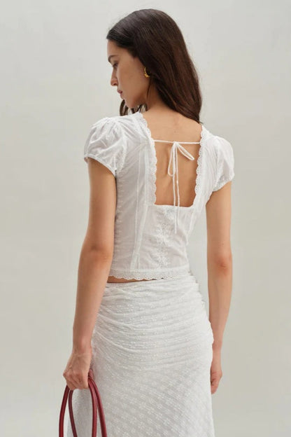 White - Women's white short-sleeve tailored blouse featuring intricate floral embroidery, a deep V-neckline with scalloped lace trim, and a delicate tie-front detail at the bust.