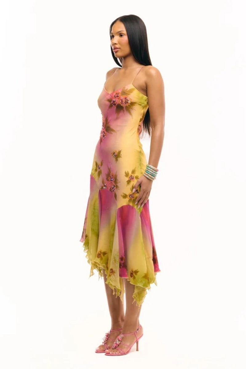 Multicolor - Women's midi-length slip dress featuring a vibrant pink and yellow ombre gradient, scattered floral print, thin straps, and a flowing asymmetrical handkerchief hemline.
