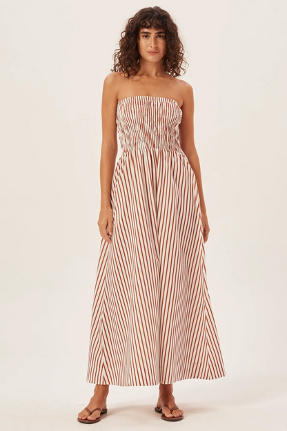 Green - Women's strapless maxi dress featuring a shirred bandeau bodice and bold green and white vertical stripes, styled with a woven straw tote bag.
