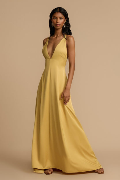 Gold - A woman modelling an elegant, floor-length golden yellow sleeveless maxi dress featuring a deep plunge V-neckline and a smooth, flowing skirt with a subtle satin-like sheen.