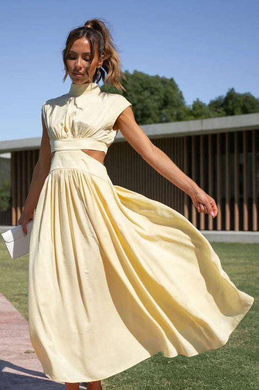 Yellow - A woman walks outdoors in a pale yellow high-neck midi dress with cap sleeves, a side waist cutout, and a full A-line skirt that flows with her movement.