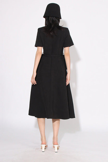 Black - A woman wearing a bright red, short-sleeved midi dress featuring a notched V-neckline, a thin waist belt, and two large 3D rosette embellishments on the A-line skirt.