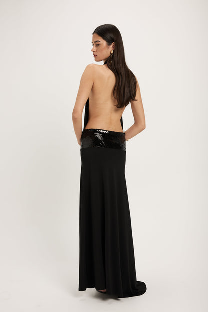 XL - Women's dark red maxi dress featuring a draped cowl halter neckline, an open back, and a wide sequin-embellished band at the waist, falling to a floor-length hem.