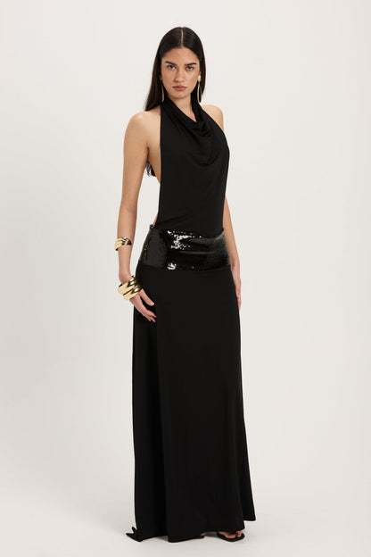 XL - Women's dark red maxi dress featuring a draped cowl halter neckline, an open back, and a wide sequin-embellished band at the waist, falling to a floor-length hem.