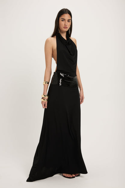 XL - Women's dark red maxi dress featuring a draped cowl halter neckline, an open back, and a wide sequin-embellished band at the waist, falling to a floor-length hem.