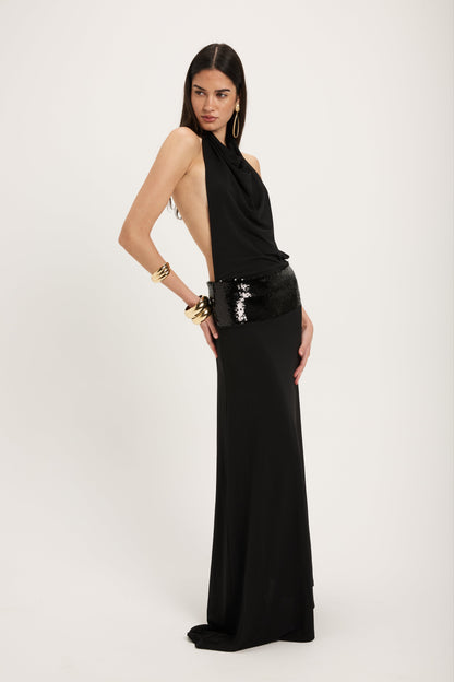 XL - Women's dark red maxi dress featuring a draped cowl halter neckline, an open back, and a wide sequin-embellished band at the waist, falling to a floor-length hem.