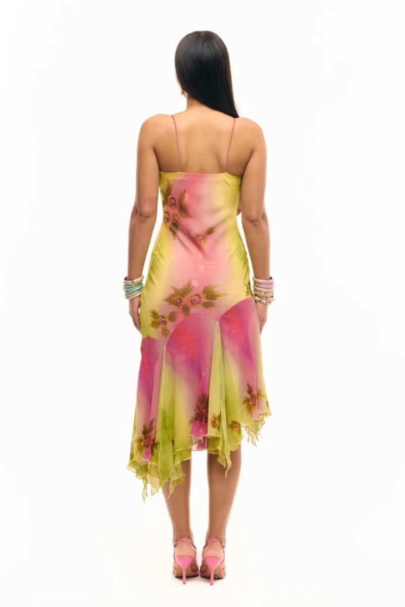 Multicolor - Women's midi-length slip dress featuring a vibrant pink and yellow ombre gradient, scattered floral print, thin straps, and a flowing asymmetrical handkerchief hemline.