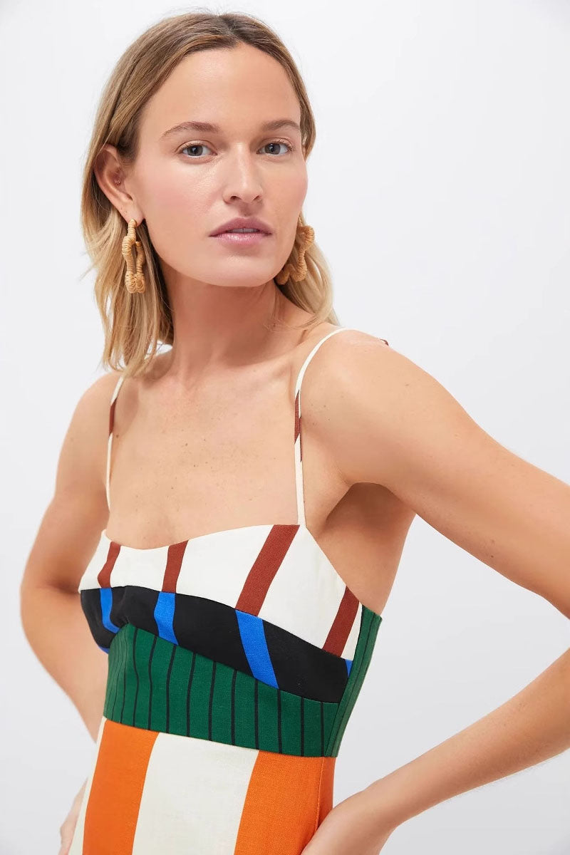 Multi - A woman wearing a vibrant maxi dress with spaghetti straps and a bold, multi-coloured geometric block stripe pattern.
