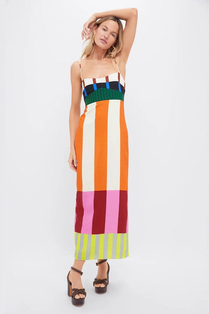 Multi - A woman wearing a vibrant maxi dress with spaghetti straps and a bold, multi-coloured geometric block stripe pattern.