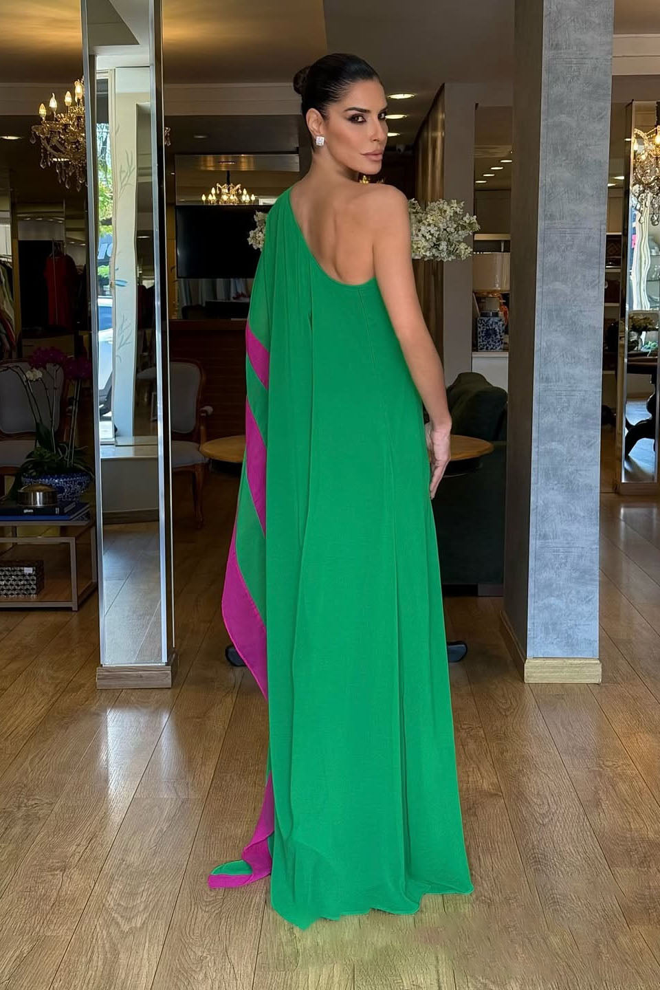 Green - Women's bright green one-shoulder maxi dress featuring a dramatic asymmetrical draped cape sleeve with a vibrant pink contrast trim.