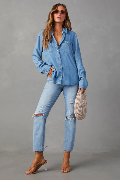 Blue - Women's relaxed-fit chambray button-down shirt featuring dual chest pockets and rolled sleeves, styled with denim jeans.