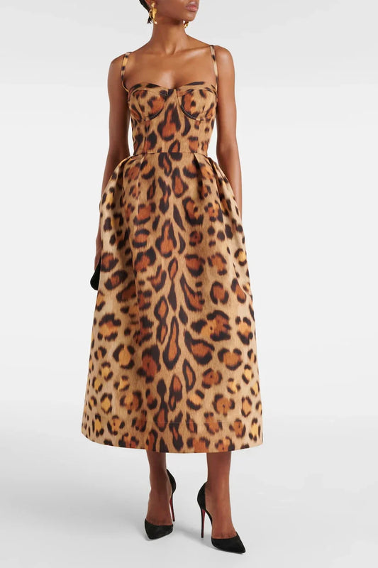 A woman wearing a structured midi dress with a corset bodice and full A-line skirt in a bold leopard print.