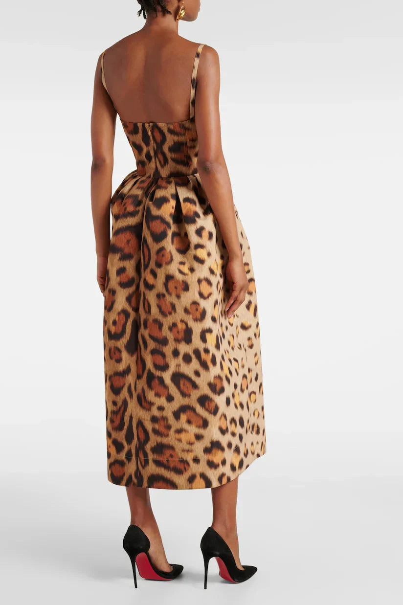 A woman wearing a structured midi dress with a corset bodice and full A-line skirt in a bold leopard print.