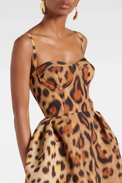 A woman wearing a structured midi dress with a corset bodice and full A-line skirt in a bold leopard print.