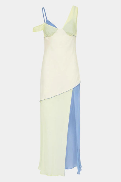 Ecru Multi - A woman wearing a long, fluid colourblock maxi dress in pale yellow, cream, and light blue, featuring an asymmetrical neckline, a high side slit, and semi-sheer skirt panels.