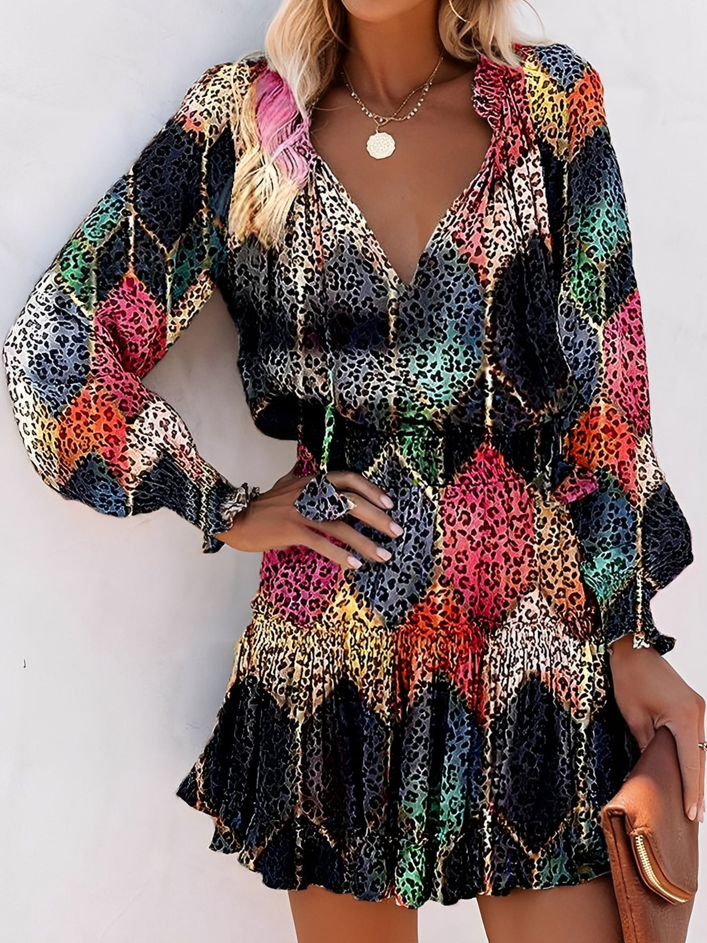 Black - Woman wearing a woven animal-print mini dress with long sleeves, a V-neckline with ties, a smocked waist, and a tiered ruffle skirt.