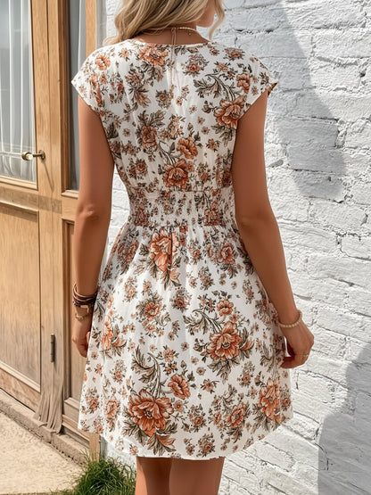 Orange - Woman modelling a lightweight animal-print v-neck mini dress with cap sleeves and a shirred waist, holding a woven bag against a white brick wall.