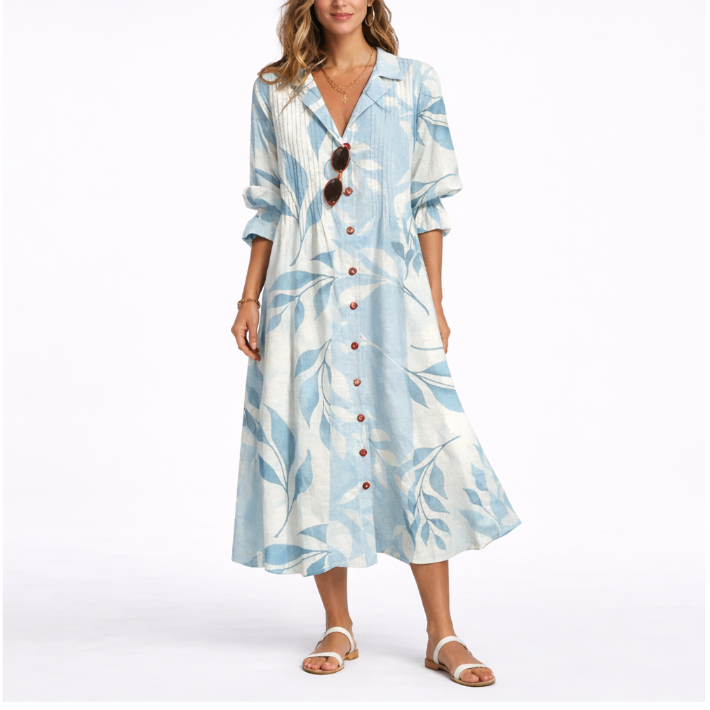 Blue & White - Woman wearing a relaxed botanical print midi shirt dress with a collar, front buttons, and 3/4 sleeves.