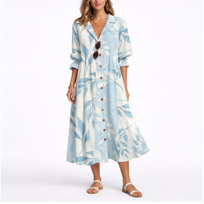 Blue & White - Woman wearing a relaxed botanical print midi shirt dress with a collar, front buttons, and 3/4 sleeves.