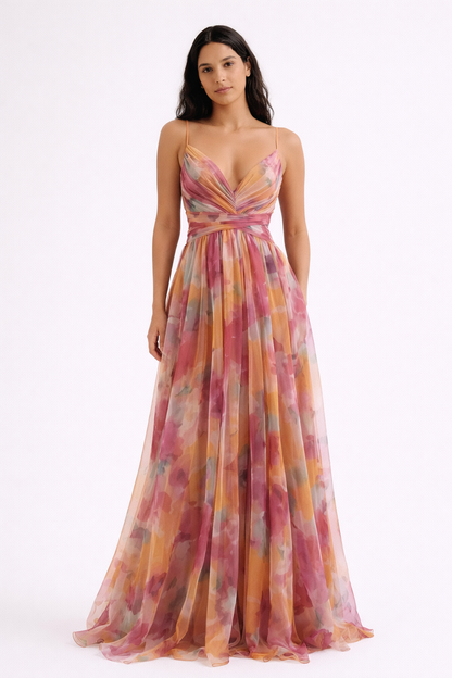 Pink - A woman wearing a flowing, floor-length floral maxi dress with a ruched V-neck bodice and delicate straps.