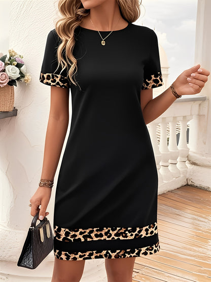 Black - Woman wearing a short-sleeve shift dress featuring a high crew neckline and contrasting leopard print trim on the sleeves and hem, standing on a balcony.