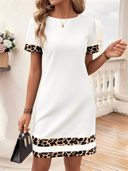 White - Woman wearing a short-sleeve shift dress featuring a high crew neckline and contrasting leopard print trim on the sleeves and hem, standing on a balcony.