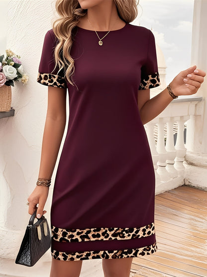 Burgundy - Woman wearing a short-sleeve shift dress featuring a high crew neckline and contrasting leopard print trim on the sleeves and hem, standing on a balcony.