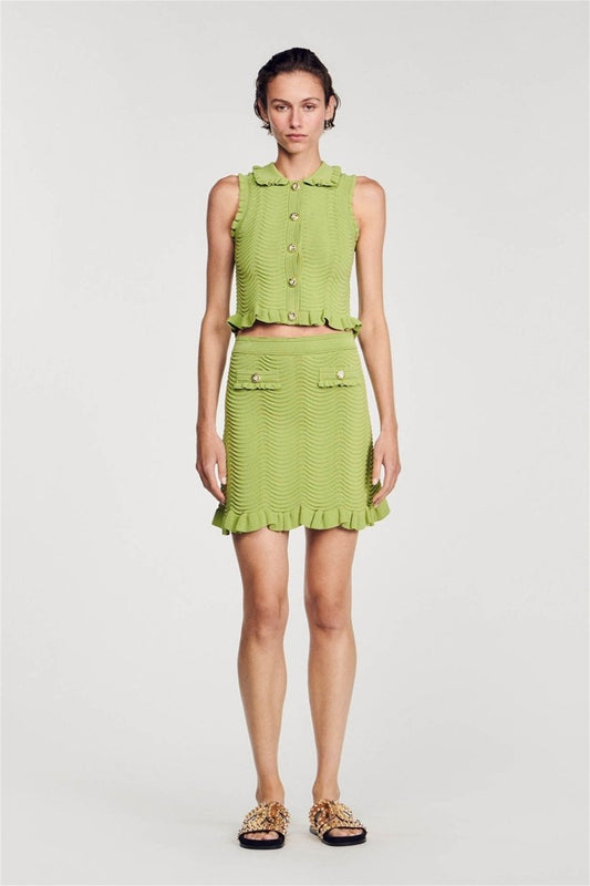 Green - Women's matching two-piece set featuring a sleeveless, collared crop top with gold buttons and a high-waisted mini skirt, both designed in a wavy textured knit with ruffle trims.