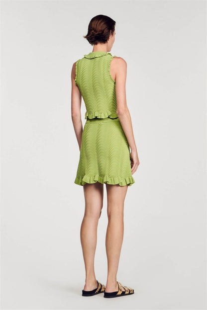 Green - Women's matching two-piece set featuring a sleeveless, collared crop top with gold buttons and a high-waisted mini skirt, both designed in a wavy textured knit with ruffle trims.