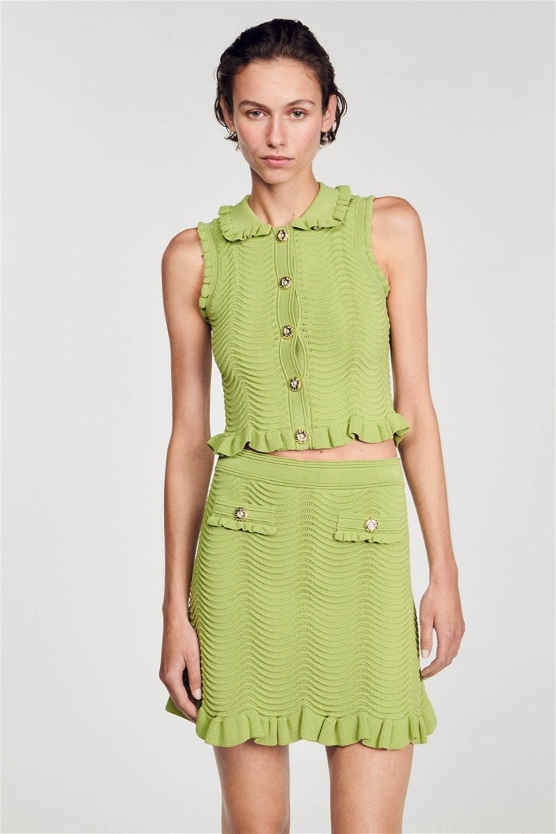 Green - Women's matching two-piece set featuring a sleeveless, collared crop top with gold buttons and a high-waisted mini skirt, both designed in a wavy textured knit with ruffle trims.