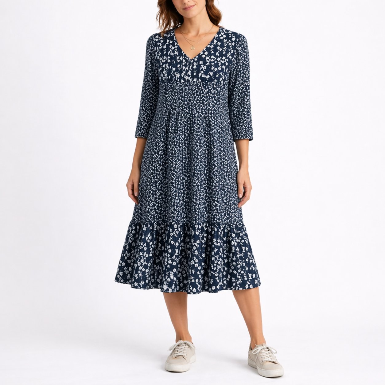 Blue - Model wearing a ditsy floral V-neck midi dress with 3/4-length sleeves and a tiered hemline.