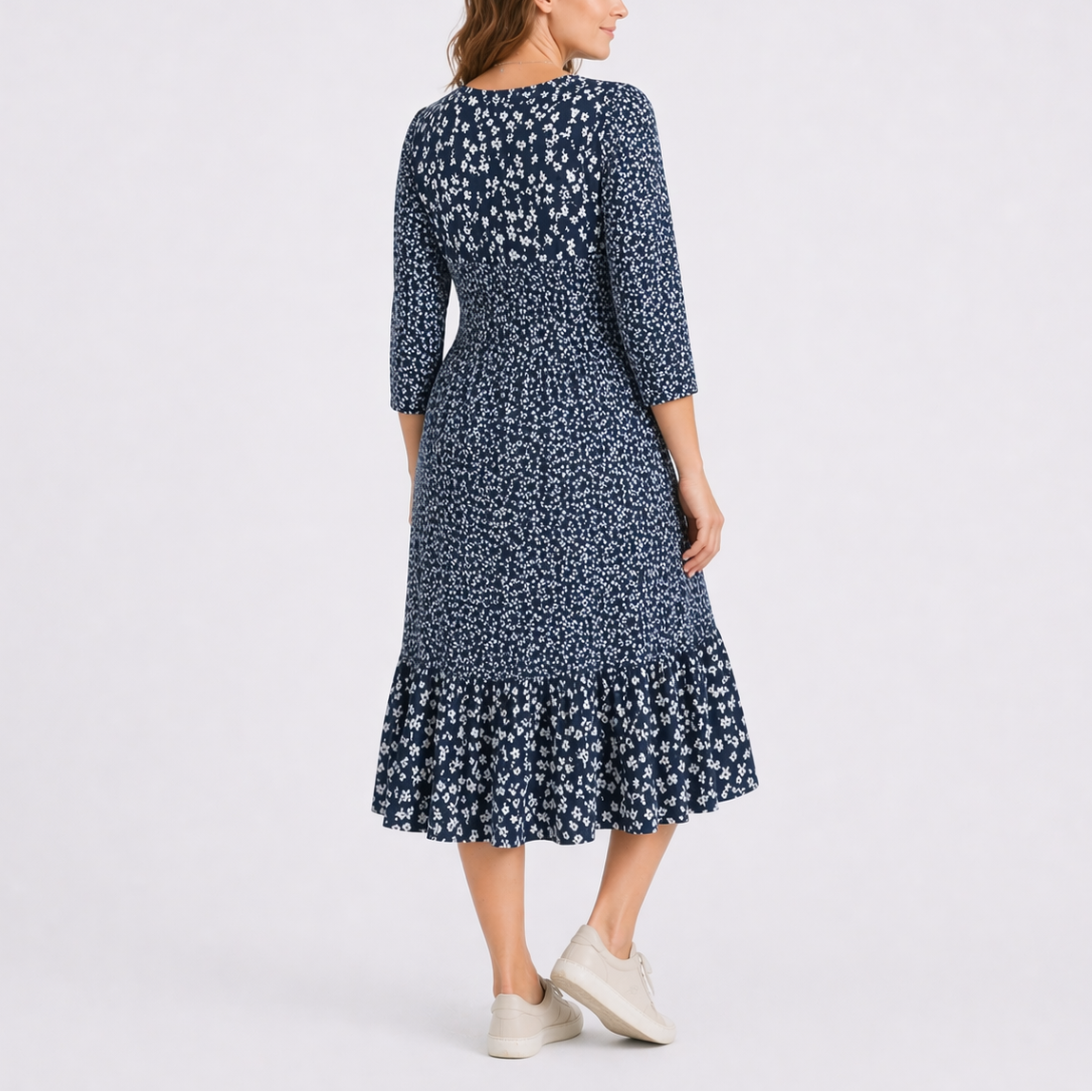 Blue - Model wearing a ditsy floral V-neck midi dress with 3/4-length sleeves and a tiered hemline.