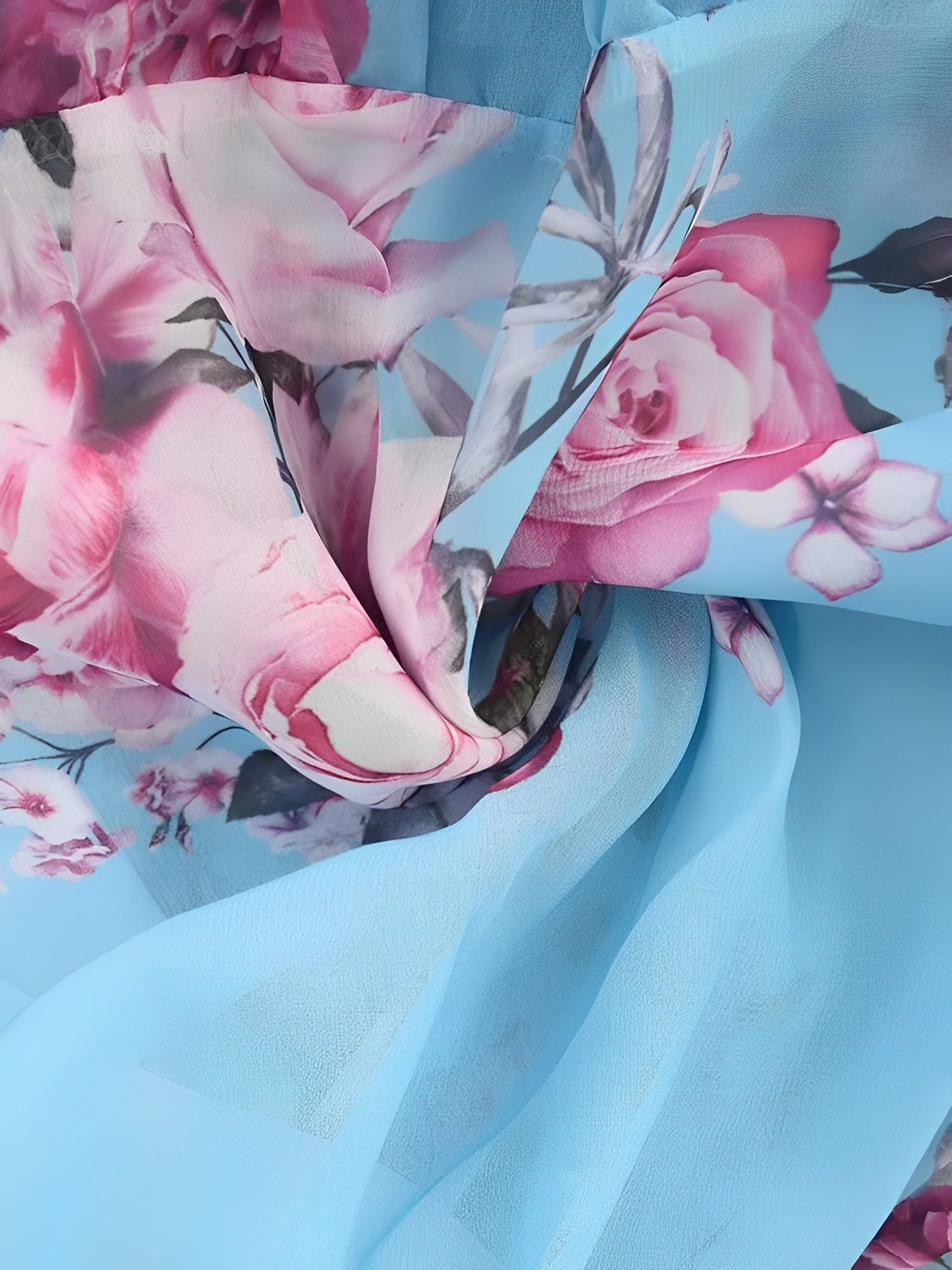 Light Blue - Woman wearing a floral print cold-shoulder tiered dress with a ruffle overlay neckline.