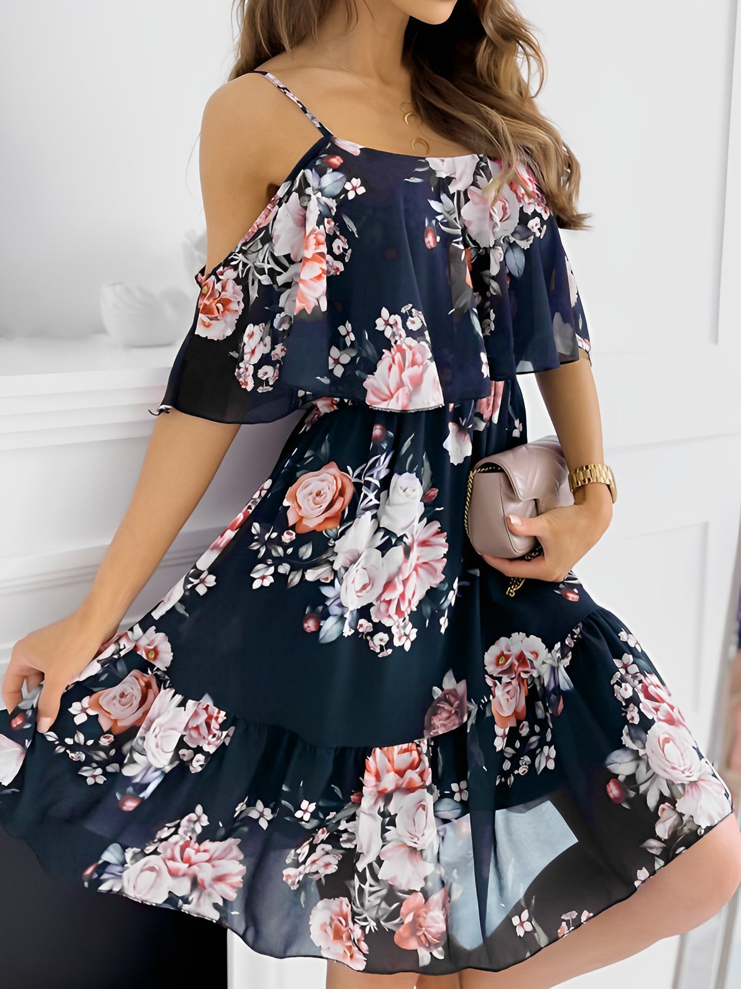 Black - Woman wearing a floral print cold-shoulder tiered dress with a ruffle overlay neckline.