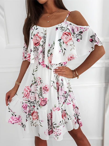 White - Woman wearing a floral print cold-shoulder tiered dress with a ruffle overlay neckline.