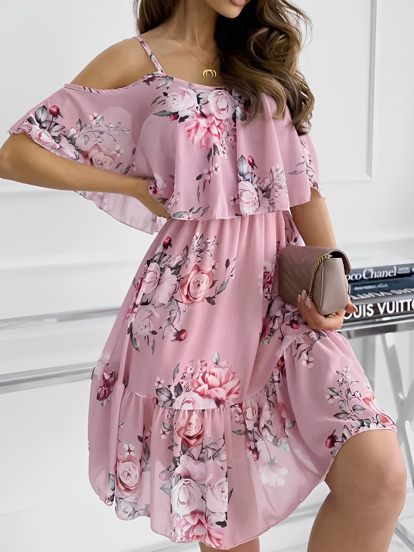 Pink - Woman wearing a floral print cold-shoulder tiered dress with a ruffle overlay neckline.