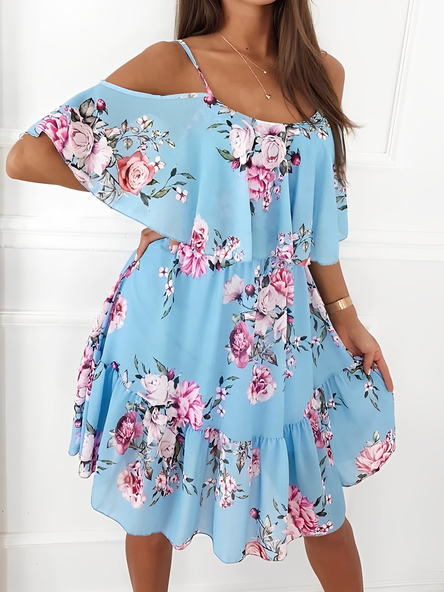Light Blue - Woman wearing a floral print cold-shoulder tiered dress with a ruffle overlay neckline.