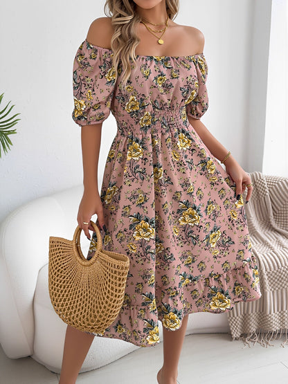 Pink - Woman wearing a floral print off-the-shoulder midi dress with a smocked waist and short puff sleeves, holding a woven straw bag